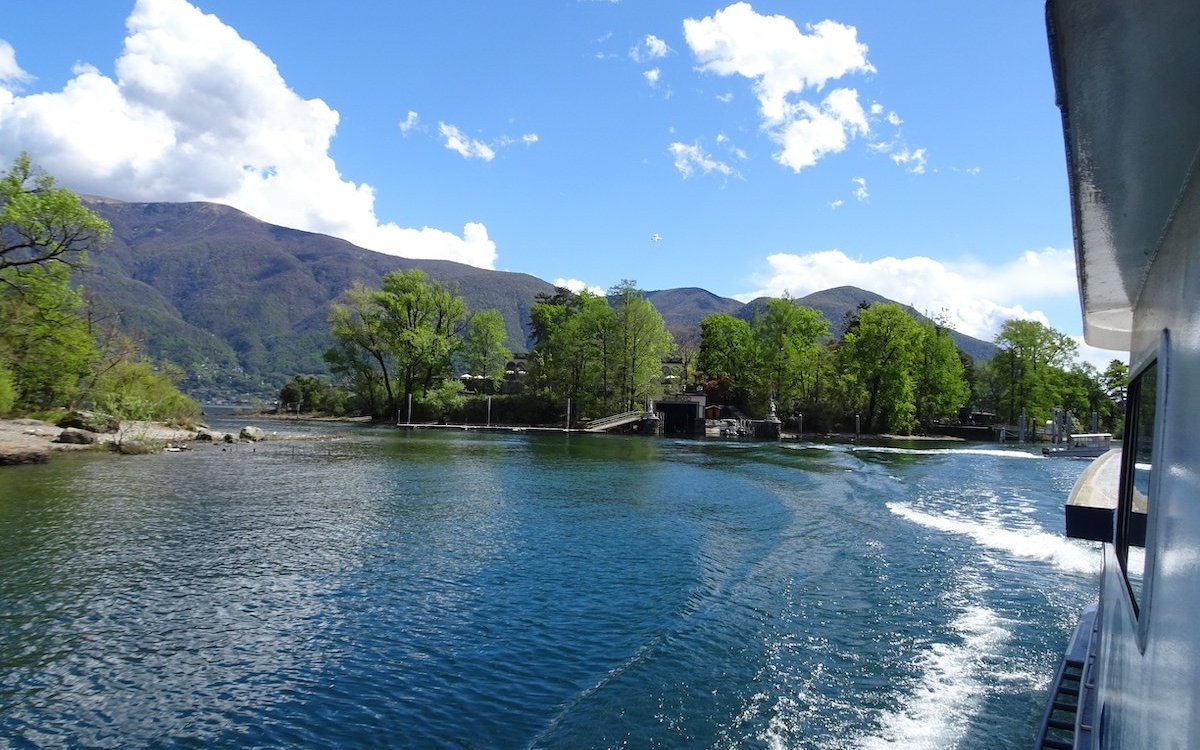 Nach dem Besuch legt das Schiff ab und schneidet durch das blaue Wasser des Lago Maggiore. 